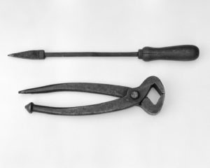 Black & White Photograph Of Old Soldering Iron And Pincers